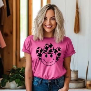 Cowgirl smiley face with a cow print hat, hot pink/fuchsia shirt
